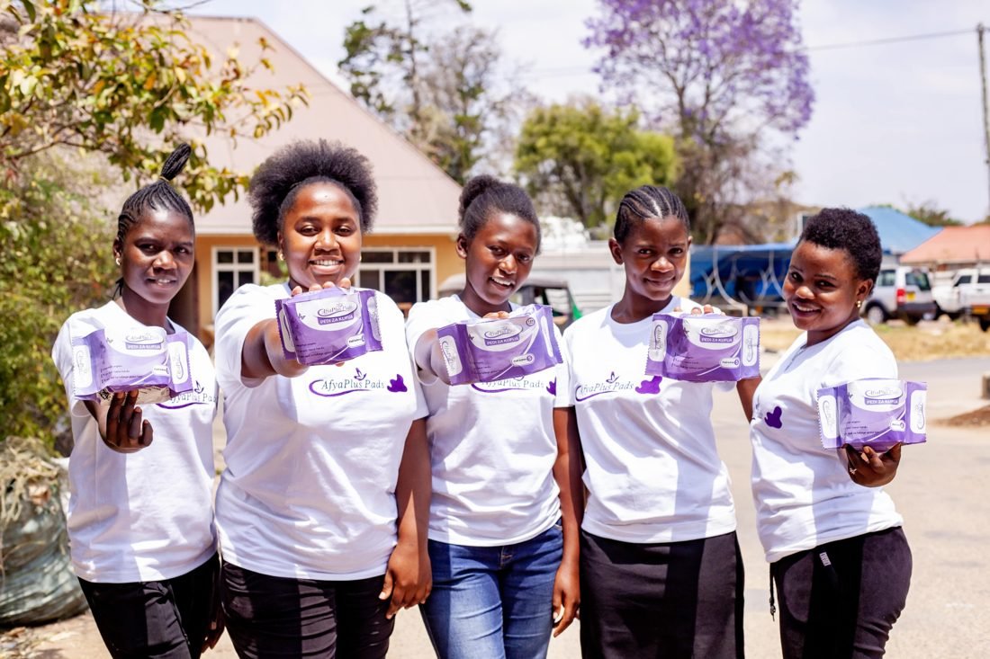 Girls proudly holding Afyaplus reusable pads